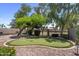 Private backyard featuring a putting green, mature trees, and a charming outdoor space at 1761 E Countrywalk Ln, Chandler, AZ 85225