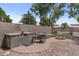 Charming backyard features a built-in BBQ area, fire pit, and low-maintenance landscaping for outdoor enjoyment at 1761 E Countrywalk Ln, Chandler, AZ 85225