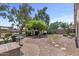 Spacious backyard showcasing a putting green, beautiful landscaping, and an inviting patio area at 1761 E Countrywalk Ln, Chandler, AZ 85225