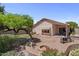 Private backyard with patio, lush landscaping, and fire pit offers a serene outdoor retreat at 1761 E Countrywalk Ln, Chandler, AZ 85225
