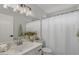 Clean bathroom with a single sink vanity and tub shower combo with white shower curtain at 1761 E Countrywalk Ln, Chandler, AZ 85225