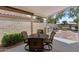 Inviting covered patio features a dining set for outdoor meals and relaxation in a backyard setting at 1761 E Countrywalk Ln, Chandler, AZ 85225