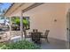 Relaxing covered patio with dining set and a view of a landscaped backyard for enjoyable outdoor living at 1761 E Countrywalk Ln, Chandler, AZ 85225