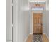 Inviting entryway featuring a wooden door, stylish rug, and modern lighting fixture at 1761 E Countrywalk Ln, Chandler, AZ 85225