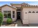 Close-up view of a home's inviting entrance, featuring a black front door and well-manicured landscaping at 1761 E Countrywalk Ln, Chandler, AZ 85225