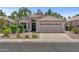 Well-kept home featuring a two-car garage, desert landscaping, and a welcoming entrance at 1761 E Countrywalk Ln, Chandler, AZ 85225