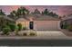 Charming home with a well-maintained front yard, mature landscaping, and a two-car garage at 1761 E Countrywalk Ln, Chandler, AZ 85225