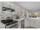 Bright kitchen featuring white cabinets, stainless steel appliances, and a stylish tile backsplash at 1761 E Countrywalk Ln, Chandler, AZ 85225