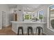 Well-lit kitchen area featuring a breakfast bar and views of the front yard at 1761 E Countrywalk Ln, Chandler, AZ 85225