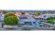 Aerial view of a backyard featuring a covered patio, desert landscaping, and solar panels at 18161 N 63Rd Ln, Glendale, AZ 85308