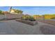 Gravel backyard featuring desert plantings with a raised brick border at 18161 N 63Rd Ln, Glendale, AZ 85308