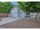 Low maintenance yard with gravel, mature shade tree, and desert plantings at 18161 N 63Rd Ln, Glendale, AZ 85308