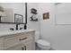 Charming half-bathroom with modern fixtures, decorative shelves, and a stylish mirror, creating a welcoming and functional space at 18161 N 63Rd Ln, Glendale, AZ 85308