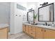 Bright bathroom with double vanity, modern fixtures, decorative mirror, and stylish decor, creating a functional space at 18161 N 63Rd Ln, Glendale, AZ 85308
