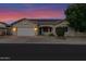 Attractive home with solar panels, a two-car garage, and a well-maintained xeriscaped yard at 18161 N 63Rd Ln, Glendale, AZ 85308