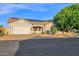 Well-kept home featuring a two-car garage, low-maintenance landscaping, and energy-efficient solar panels at 18161 N 63Rd Ln, Glendale, AZ 85308