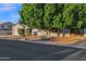 Charming home featuring desert landscaping, a two-car garage, and a mature shade tree at 18161 N 63Rd Ln, Glendale, AZ 85308