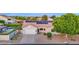 Well-maintained home featuring solar panels, a two-car garage, and a beautifully xeriscaped front yard at 18161 N 63Rd Ln, Glendale, AZ 85308