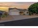 Inviting single-story home with a two-car garage, solar panels, and desert-friendly landscaping at 18161 N 63Rd Ln, Glendale, AZ 85308