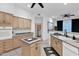 This spacious kitchen has modern appliances, ample storage, and views to the laundry area at 18161 N 63Rd Ln, Glendale, AZ 85308