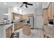 This kitchen has modern stainless appliances, a central island, and wood cabinets at 18161 N 63Rd Ln, Glendale, AZ 85308
