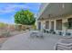 Covered patio with dining set, desert landscaping, and space for outdoor seating and enjoyment at 18161 N 63Rd Ln, Glendale, AZ 85308
