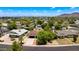 Aerial view of the home in a neighborhood surrounded by lush greenery and distant mountain views at 1820 W Seldon Way, Phoenix, AZ 85021