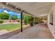 Covered back patio features a concrete foundation, desert landscaping and grassy backyard area at 1820 W Seldon Way, Phoenix, AZ 85021