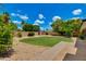 This grassy backyard features mature landscaping, brick pathway and wooden privacy fence at 1820 W Seldon Way, Phoenix, AZ 85021
