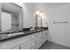 Bathroom featuring double sinks with a gray countertop and white cabinets, along with tile flooring at 1820 W Seldon Way, Phoenix, AZ 85021