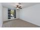 Bedroom with carpet, a ceiling fan, and a window with striped drapes at 1820 W Seldon Way, Phoenix, AZ 85021