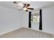Bedroom with carpet, a ceiling fan, and a window with dark drapes at 1820 W Seldon Way, Phoenix, AZ 85021