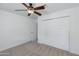 Bedroom with carpet flooring, ceiling fan and a large closet with sliding doors at 1820 W Seldon Way, Phoenix, AZ 85021