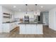 Bright kitchen with white cabinetry, stainless steel appliances, and an island with pendant lighting at 1820 W Seldon Way, Phoenix, AZ 85021