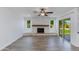 Living room with brick fireplace, wood beam mantel, and sliding glass door to the backyard at 1820 W Seldon Way, Phoenix, AZ 85021