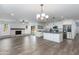 Open-concept living space with a fireplace, modern fixtures, and access to the renovated kitchen at 1820 W Seldon Way, Phoenix, AZ 85021
