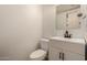 Half bathroom featuring toilet, vanity, and a sink at 18250 N Cave Creek Rd # 139, Phoenix, AZ 85032