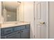 Neutral-toned bathroom boasts a blue vanity with stylish hardware and a large mirror at 18250 N Cave Creek Rd # 139, Phoenix, AZ 85032
