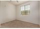 This bright bedroom features neutral carpet and a window with blinds for natural light at 18250 N Cave Creek Rd # 139, Phoenix, AZ 85032