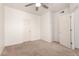 Spacious bedroom with carpet, ceiling fan, and two closets at 18250 N Cave Creek Rd # 139, Phoenix, AZ 85032