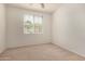 This bright bedroom features neutral carpet and a window with blinds for natural light at 18250 N Cave Creek Rd # 139, Phoenix, AZ 85032