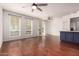 Open living room with hardwood floors, ceiling fans, and access to the outdoor patio at 18250 N Cave Creek Rd # 139, Phoenix, AZ 85032