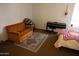 Bedroom featuring a comfortable seating area, a keyboard, and stylish rug at 1927 E Hampton Ave # 208, Mesa, AZ 85204