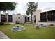 Outdoor picnic area with built in concrete tables, benches, and trash cans, and mature landscaping throughout at 1927 E Hampton Ave # 208, Mesa, AZ 85204