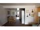 Open dining room with a wooden table, chairs, and view into the kitchen at 1927 E Hampton Ave # 208, Mesa, AZ 85204