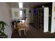 Open dining room with a wooden table, chairs, and a large shelving unit at 1927 E Hampton Ave # 208, Mesa, AZ 85204