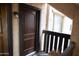 A welcoming front door with dark wood and a black door knob, accompanied by a black iron light fixture at 1927 E Hampton Ave # 208, Mesa, AZ 85204