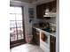 Kitchen featuring white appliances and dark wood cabinets at 1927 E Hampton Ave # 208, Mesa, AZ 85204