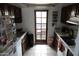 Cozy kitchen featuring wooden cabinets, white countertops, and access to a balcony or patio at 1927 E Hampton Ave # 208, Mesa, AZ 85204