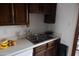 Kitchen space with double sink, wooden cabinets, and white countertops at 1927 E Hampton Ave # 208, Mesa, AZ 85204